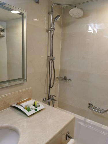 a bathroom with a shower and a sink and a mirror at Al Rabea Hotel in Najran