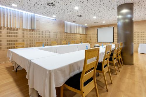 a conference room with a long table and chairs at Daniya Alicante in Alicante