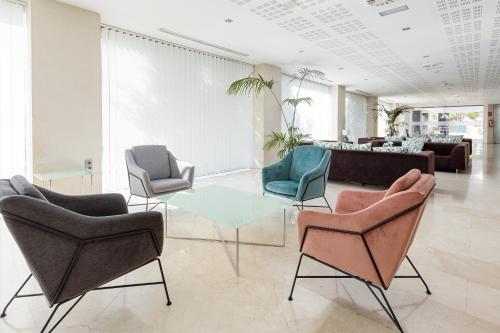 a lobby with chairs and a table and a couch at Daniya Alicante in Alicante