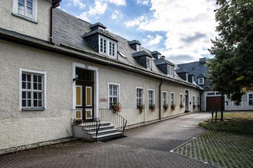 a building with stairs and windows on a street at Rüstzeitenheim Sonnenschein in Saalburg