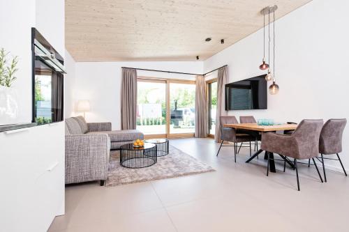 a living room with a couch and a table at Apartment Velden - 24 Home im Zentrum in Velden am Wörthersee