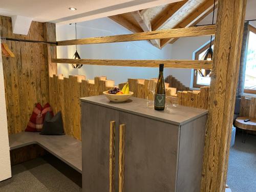 a wine bottle on a counter in a room with wooden walls at Hotel Jägerhof in Kaunertal