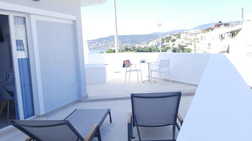 a room with two chairs and a table on a balcony at Naiades Marina Hotel in Agios Nikolaos