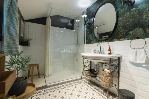 a bathroom with a shower and a sink and a mirror at Puhek breg in Krapina