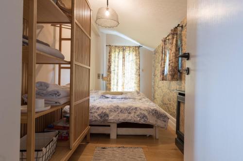 a bedroom with a bunk bed and a window at Puhek breg in Krapina