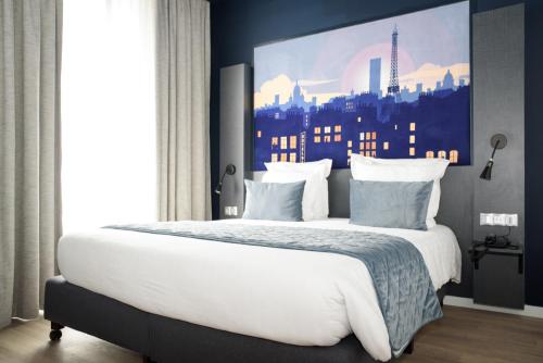 a bedroom with a large white bed with a city backdrop at Hôtel Des Arts-Bastille in Paris