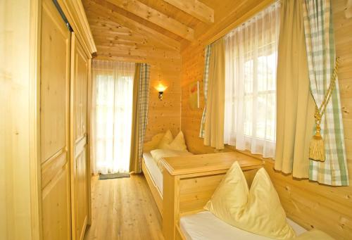 a room with two beds in a wooden cabin at Alpenchalets - Obholzer in Kühtai