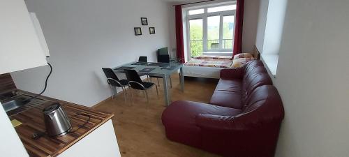 a living room with a couch and a table at Aparthotel Rezidence Club Canada Lipno in Lipno nad Vltavou