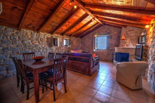 a living room with a table and a couch at Achelatis Traditional Guest Houses in Areopolis
