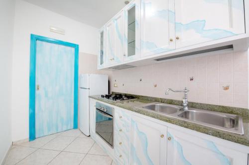 a kitchen with a sink and a refrigerator at Suitevesuvio in Sorrento