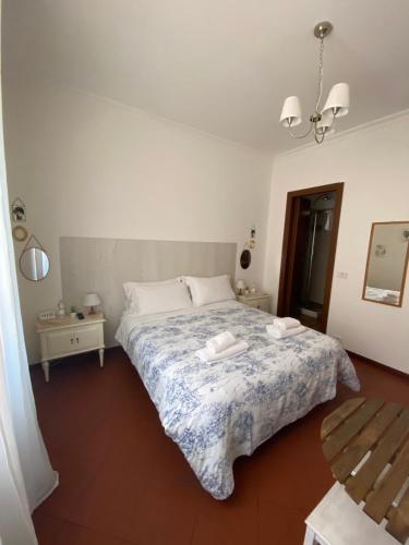 a bedroom with a bed with a blue and white blanket at Al Ponte Del Papa B&B in Rome