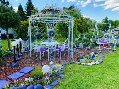 a gazebo with a table and chairs in a garden at Apartament Rodzinny z ogrodem in Cieszyn