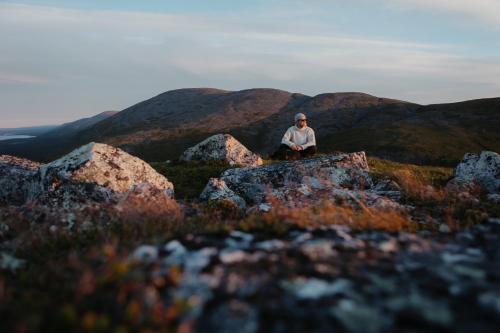 a person sitting on top of a mountain at Lapland Hotels Ylläskaltio in Äkäslompolo