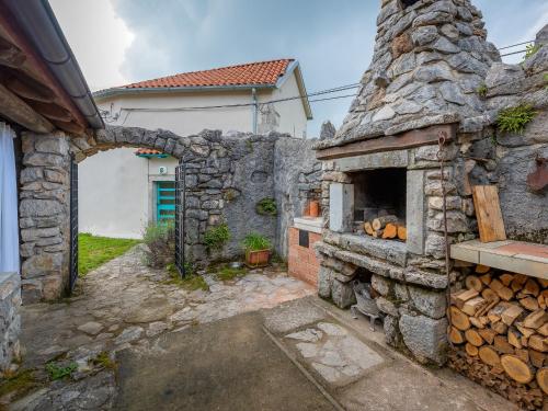 an outdoor pizza oven in a stone building at Holiday home Dane 22 Ucka in Buzet