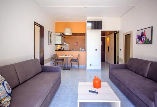 a living room with two couches and a table at Turial Old Town Ocean View in Albufeira