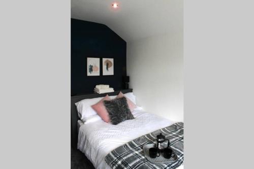 a bedroom with a bed with a black headboard at StayWell Apt By Horizon Stays in Middlesbrough