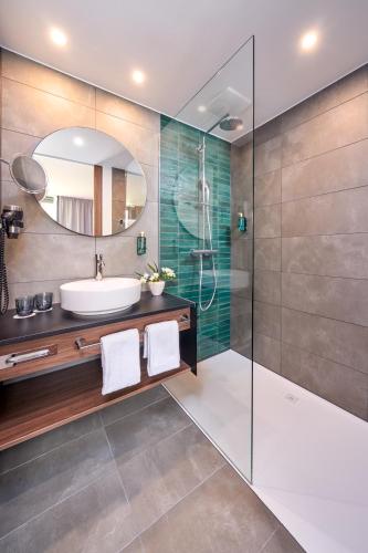 a bathroom with a sink and a shower at Karls Hotel in Sigmaringen