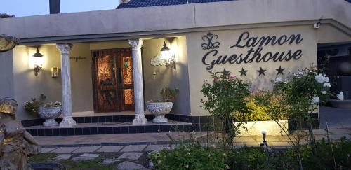 a store with a sign on the front of a building at Lamon Guesthouse in Kroonstad