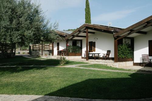una casa con mesa y sillas en un patio en Pantalica Ranch Agriturismo Siciliano en Sortino