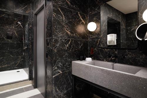 a bathroom with a sink and a mirror at Malmaison York in York