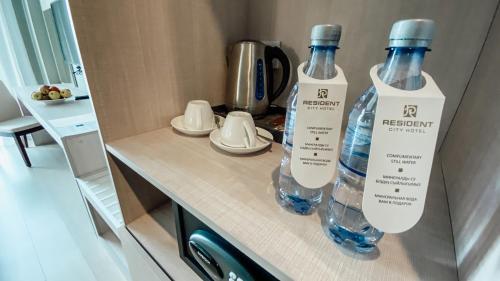 two bottles of water sitting on top of a counter at Resident City Hotel in Almaty