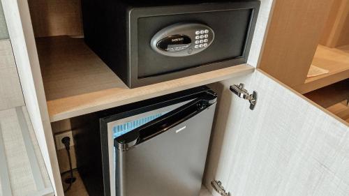a microwave oven sitting on top of a refrigerator at Resident City Hotel in Almaty