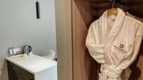 a towel hanging on a wall in a bathroom at Resident City Hotel in Almaty