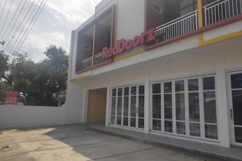 a building with a sign on the side of it at RedDoorz near Universitas Muhammadiyah Purwokerto in Kembaran