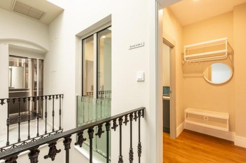 a staircase in a house with a mirror at Kayser Premium Suites in Seville