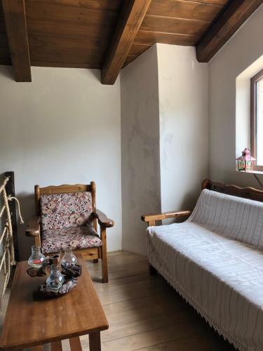 - une chambre avec un lit, une chaise et une table dans l'établissement Poliani Village, à Poliána