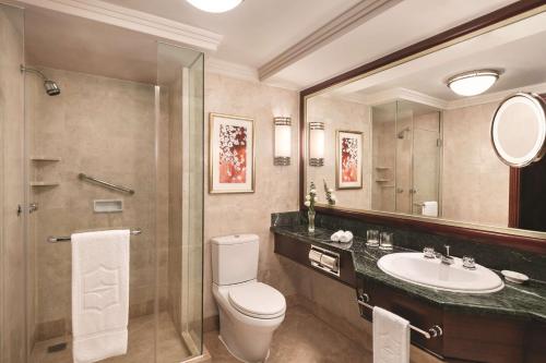 a bathroom with a toilet and a sink and a mirror at Shangri-La Wuhan,Close to The Mixc with three subway lines in Wuhan