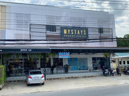 a white car parked in front of a building at Mystays Phuket in Phuket Town
