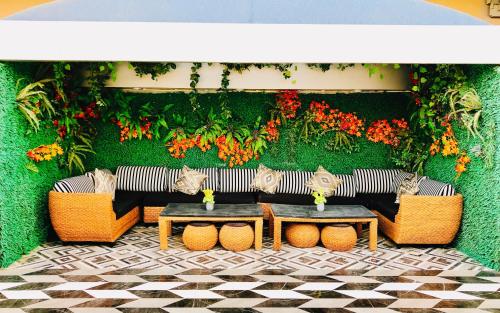 a patio with a couch and tables and flowers at Riyadh Inn Hotel in Riyadh