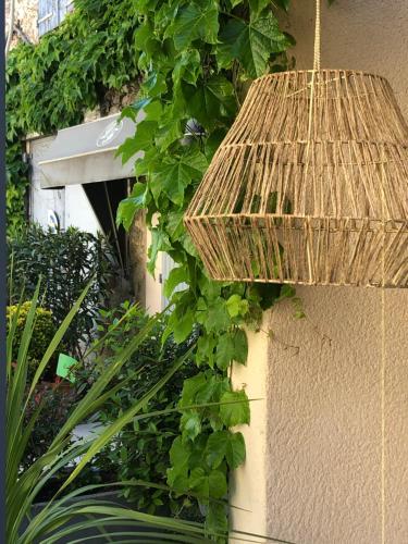 a wicker bird house on the side of a building at Logis Hôtel La Fenière in La Bouilladisse
