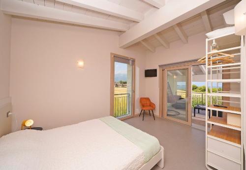 a bedroom with a bed and a balcony at Gardaliva 5 in Manerba del Garda