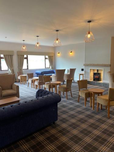 a living room with couches and chairs and a fireplace at Croit Anna Hotel in Fort William