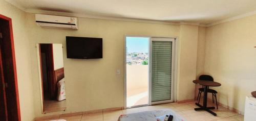 a room with a flat screen tv on the wall at Colorado Plaza Hotel in Rio Verde