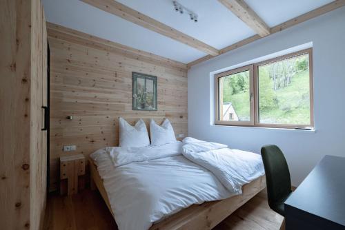 A bed or beds in a room at Franz Johann Appartements - near slopes - Reiteralm