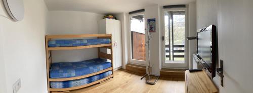 two bunk beds in a room with a window at Stunning view in Breuil-Cervinia
