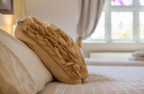 a pair of shoes sitting on top of a bed at Grove Lodge in Gosport