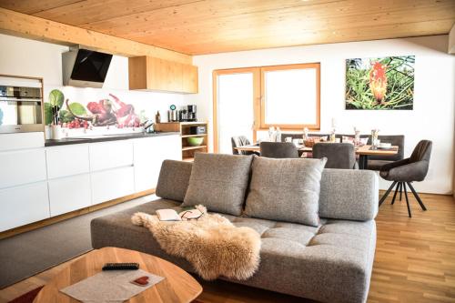 a living room with a couch and a table at Haus Alpenblick in Schröcken