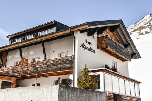 a building with a sign on the side of it at Haus Alpenblick in Schröcken