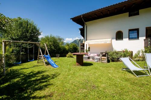 a yard with a playground and a swing at Tyrol Appartements in Ehrwald