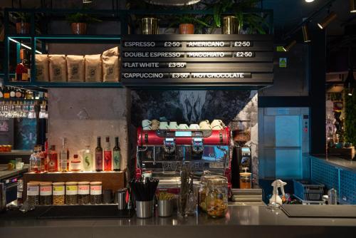 a kitchen with a bar with a coffee machine at YOTEL Manchester Deansgate in Manchester