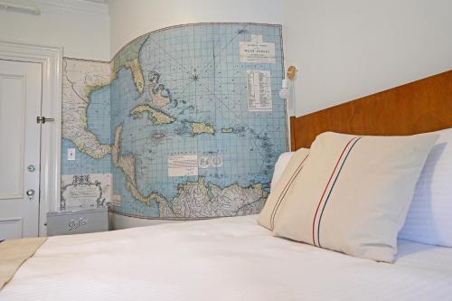 a bedroom with a large map on the wall at The Hotel Marblehead in Marblehead