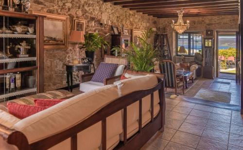 a living room with a couch and chairs in a room at Hotel Rústico Finisterrae in Fisterra