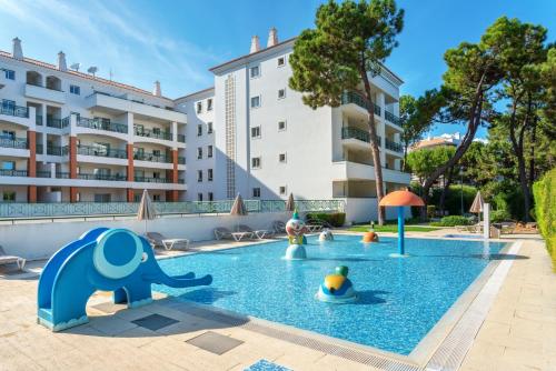 an outdoor swimming pool with toys in a resort at AP Victoria Sports & Beach in Albufeira