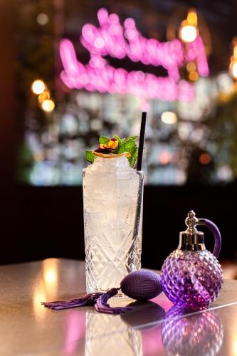 a drink sitting on a table with purple decorations at YOTEL Manchester Deansgate in Manchester