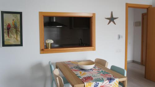 a dining room with a table and a mirror at Apartamentos Calma Rentals in Torremolinos