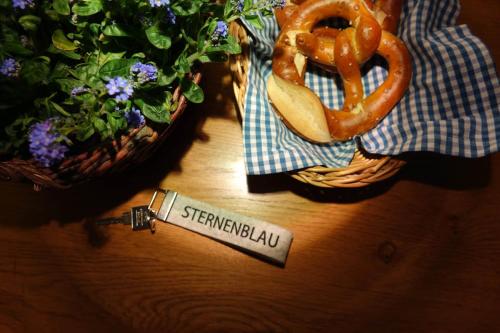 a wooden table with pretzels and a sign that says shepherdialahu at Schittlerhaus in Oberstdorf
